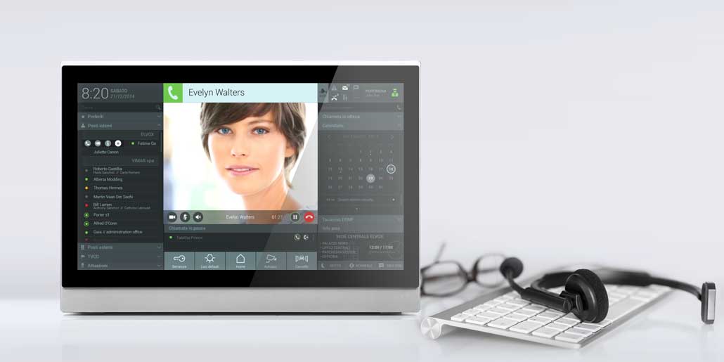 Vimar Elvox Ip-based Porter Center with access control, videocall center, building surveillance and energy monitoring graphic icon and usability design quickpartners LCD screen with keyboard and headset on white desk