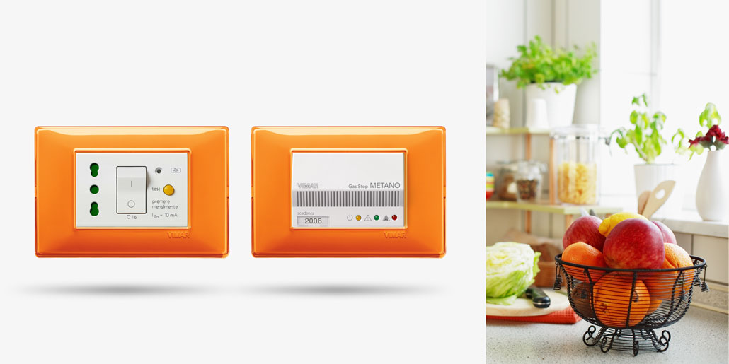 Vimar Plana switch range design by quickpartners+ with many comfort and security functions as life saving switches and gas sensors in innovative design frame reflex orange in kitchen with fruits