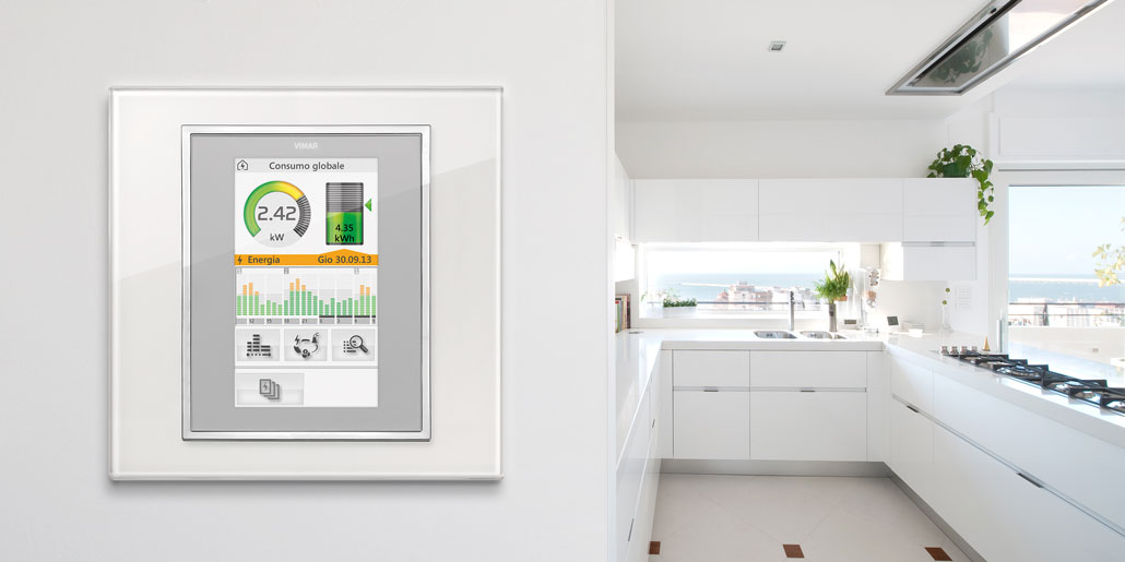 The comfortable and natural way to communicate with automated homes - Touchpanels Vimar Byme designed by quickpartners with energy monitor for making energy saving easy. Eikon full flat in white kitchen